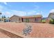 Single-story home with a low-maintenance desert landscape and charming stone riverbed at 12029 N 44Th Dr, Glendale, AZ 85304