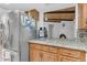 Kitchen area with stainless steel refrigerator, granite countertops, and wood cabinetry at 12029 N 44Th Dr, Glendale, AZ 85304