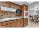 Cozy kitchen featuring wooden cabinetry, modern appliances, and a stylish tile backsplash at 12029 N 44Th Dr, Glendale, AZ 85304