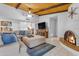 Inviting living room boasts wood-beamed ceilings, a stone fireplace, and neutral decor at 12029 N 44Th Dr, Glendale, AZ 85304