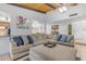 Spacious living room with a large sectional sofa, vaulted wood ceilings, and plenty of natural light at 12029 N 44Th Dr, Glendale, AZ 85304