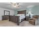 Relaxing main bedroom featuring wood furniture, a ceiling fan, and a comfortable chair at 12029 N 44Th Dr, Glendale, AZ 85304
