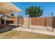 This fenced in backyard features a mix of concrete and grass, with an additional covered outdoor seating area at 1407 W Chilton St, Chandler, AZ 85224