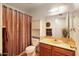 Traditional bathroom featuring a vanity, mirror, cabinet, and shower-tub combo at 1407 W Chilton St, Chandler, AZ 85224