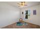 A bedroom with carpeted flooring, a ceiling fan, and a bright window at 1407 W Chilton St, Chandler, AZ 85224