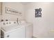 Practical laundry room featuring a washer, dryer, and laundry themed wall decorations at 1407 W Chilton St, Chandler, AZ 85224