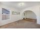 Bright living room featuring a neutral color palette and an arched entryway at 1407 W Chilton St, Chandler, AZ 85224
