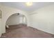 Spacious living room with an arched doorway, closet, and access to the backyard at 1407 W Chilton St, Chandler, AZ 85224