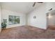Bright living room with a large window and neutral carpet at 1407 W Chilton St, Chandler, AZ 85224