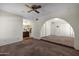 Cozy living room featuring a ceiling fan and convenient access to the bathroom at 1407 W Chilton St, Chandler, AZ 85224