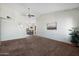 Spacious living room with vaulted ceilings, ceiling fan, and dining area at 1407 W Chilton St, Chandler, AZ 85224