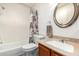 Bathroom with a shower-tub combo, decorative shower curtain, toilet, and rounded mirror at 14300 W Bell Rd # 6, Surprise, AZ 85374