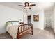 Bright bedroom with a ceiling fan, light-filled windows, and access to the laundry and bathroom at 14300 W Bell Rd # 6, Surprise, AZ 85374