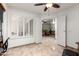 Bonus room showcasing a ceiling fan, window shutters, and an open doorway to another room at 14300 W Bell Rd # 6, Surprise, AZ 85374