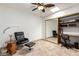Bonus room featuring a ceiling fan, tiled floors, a desk, and chair at 14300 W Bell Rd # 6, Surprise, AZ 85374