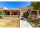 Inviting front exterior featuring a covered patio, neutral stucco, and desert landscaping at 14300 W Bell Rd # 6, Surprise, AZ 85374