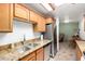 Modern kitchen featuring stainless steel appliances, granite countertops and tile flooring at 14300 W Bell Rd # 6, Surprise, AZ 85374