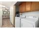 Laundry room featuring a washer, a dryer, and overhead cabinets at 14300 W Bell Rd # 6, Surprise, AZ 85374