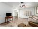 Bright living room featuring tile floors, modern ceiling fan, and natural light at 14300 W Bell Rd # 6, Surprise, AZ 85374