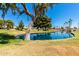 A serene pond surrounded by mature trees and lush landscaping creates a peaceful community setting at 14300 W Bell Rd # 6, Surprise, AZ 85374
