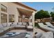 Inviting covered patio featuring outdoor seating, lounge chairs, and well-manicured landscaping at 16238 N 58Th St, Scottsdale, AZ 85254