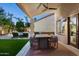 Outdoor dining and seating with backyard views, including a sparkling pool and lush landscaping at 16238 N 58Th St, Scottsdale, AZ 85254