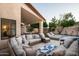 Inviting covered patio with outdoor seating, dining, and lounge areas amidst manicured landscaping at 16238 N 58Th St, Scottsdale, AZ 85254