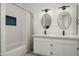 Bright bathroom with double vanity, modern fixtures, and a shower-tub combination with tiled walls at 16238 N 58Th St, Scottsdale, AZ 85254