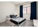 Well-lit bedroom featuring modern decor, comfortable bedding, and a window with stylish curtains at 16238 N 58Th St, Scottsdale, AZ 85254