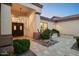 Welcoming front entrance featuring a covered doorway, manicured landscaping, and a well-lit walkway at 16238 N 58Th St, Scottsdale, AZ 85254