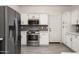 A bright kitchen featuring stainless steel appliances, ample cabinetry, and a stylish backsplash at 16238 N 58Th St, Scottsdale, AZ 85254