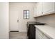 Clean laundry room with modern appliances, ample counter space, and storage cabinets at 16238 N 58Th St, Scottsdale, AZ 85254