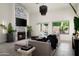 Bright living room boasts a modern fireplace, neutral tones, and views to the outdoor living area at 16238 N 58Th St, Scottsdale, AZ 85254