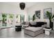 Modern living room with sleek furniture, bright lighting, and a view to the outdoor patio, inviting relaxation at 16238 N 58Th St, Scottsdale, AZ 85254