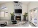 An open-concept living room with high ceilings, sleek fireplace, and sliding glass doors for natural light at 16238 N 58Th St, Scottsdale, AZ 85254