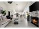 Spacious living area connects to the kitchen, showcasing open layout, fireplace, and modern finishes at 16238 N 58Th St, Scottsdale, AZ 85254
