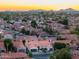 An elevated view of a community showcasing numerous homes, desert landscaping, and mountain views at 16238 N 58Th St, Scottsdale, AZ 85254