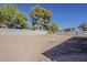 Private backyard surrounded by a block fence, offering ample space for recreation and gardening, with mature trees at 16421 N 34Th Ave, Phoenix, AZ 85053