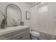 Bathroom with a gray vanity, a large mirror and a tub-shower combo at 16421 N 34Th Ave, Phoenix, AZ 85053