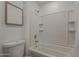 A bright bathroom featuring a shower-tub with white tile surround at 16421 N 34Th Ave, Phoenix, AZ 85053
