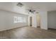 Spacious, light-filled bedroom with wood-look floors, ceiling fan, and a large window at 16421 N 34Th Ave, Phoenix, AZ 85053