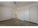 Bedroom featuring wood-look floors, a ceiling fan and a double-door closet at 16421 N 34Th Ave, Phoenix, AZ 85053
