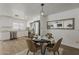 Stylish dining area with seating for four, modern light fixture, and a mirror reflecting the brick fireplace at 16421 N 34Th Ave, Phoenix, AZ 85053