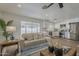 Bright living room features a modern sofa and seamless flow into the updated kitchen with stainless steel appliances at 16421 N 34Th Ave, Phoenix, AZ 85053