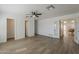 Open living room with hardwood floors, fan, and white walls at 16421 N 34Th Ave, Phoenix, AZ 85053