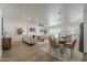 Open-concept living room with modern furnishings and decor and adjacent dining space at 16421 N 34Th Ave, Phoenix, AZ 85053