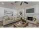 Cozy living room featuring a white brick fireplace and comfortable neutral-toned furniture at 16421 N 34Th Ave, Phoenix, AZ 85053