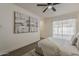 Neutral main bedroom boasts contemporary artwork, fan, and sliding doors providing seamless access to the outside at 16421 N 34Th Ave, Phoenix, AZ 85053