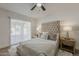 Inviting main bedroom with tufted headboard, wood nightstands, and sliding doors to outdoor patio at 16421 N 34Th Ave, Phoenix, AZ 85053