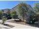 A beautiful home exterior featuring desert landscaping, mature shade trees and a brick paver driveway at 18400 W Ipswitch Way, Surprise, AZ 85374